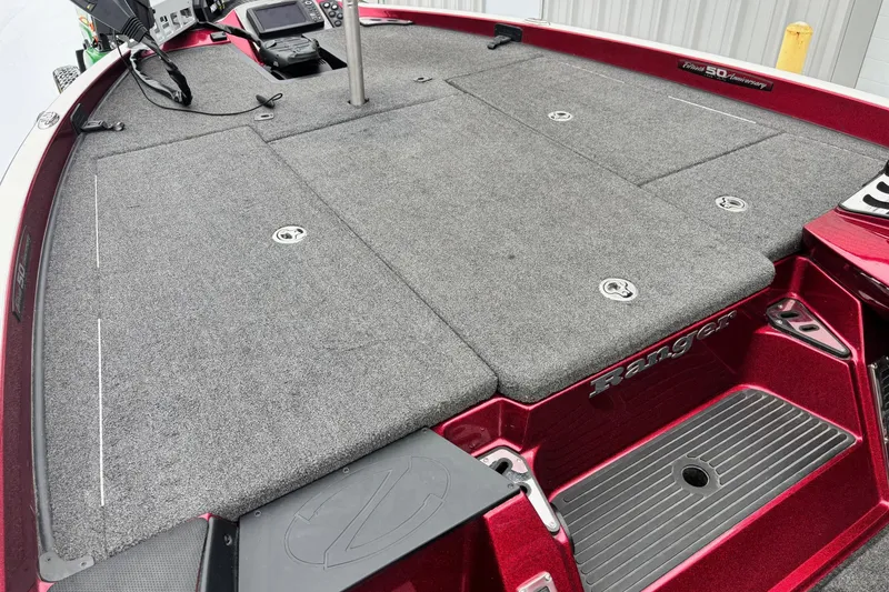 Slide: The Image of 2018 Ranger Z518 Comanche boat deck with gray carpet and red accents. - 5