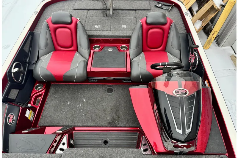 Slide: The Image of 2018 Ranger Z518 Comanche boat interior with red and gray seats, steering console, and storage compartments. - 7