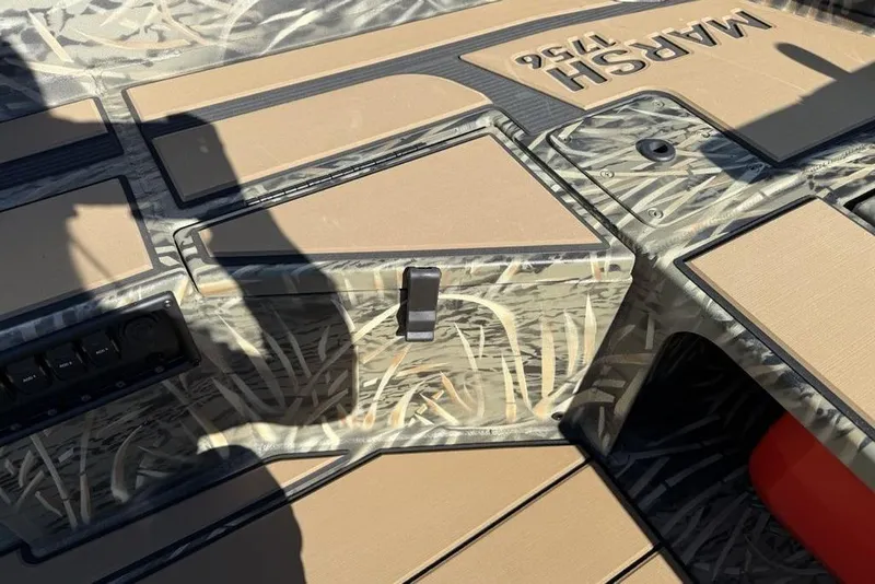 Slide: The Image of 2026 Tracker Grizzly 1756 T Marsh boat interior with camo design and storage compartments. - 14