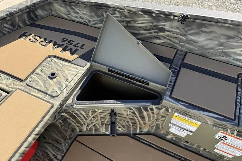 Slide: The Image of 2026 Tracker Grizzly 1756 T Marsh boat interior with open storage compartment. - 17