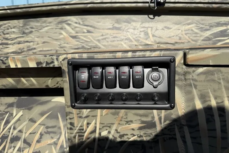 Slide: The Image of Control panel of 2026 Tracker Grizzly 1756 T Marsh boat with camouflage design. - 18
