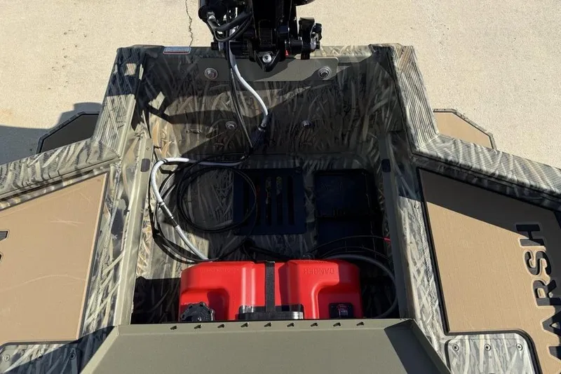 Slide: The Image of 2026 Tracker Grizzly 1756 T Marsh boat interior with camo design and red fuel tank. - 21