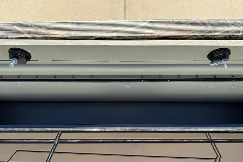 Slide: The Image of 2026 Tracker Grizzly 1756 T Marsh boat interior detail with camo pattern and hardware. - 5