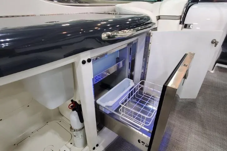 Slide: The Image of 2016 Formula 370 Super Sport yacht interior with open mini fridge and storage. - 16