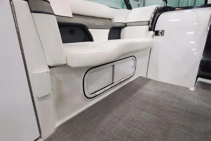 Slide: The Image of 2016 Formula 370 Super Sport interior with white seating and storage compartment. - 17
