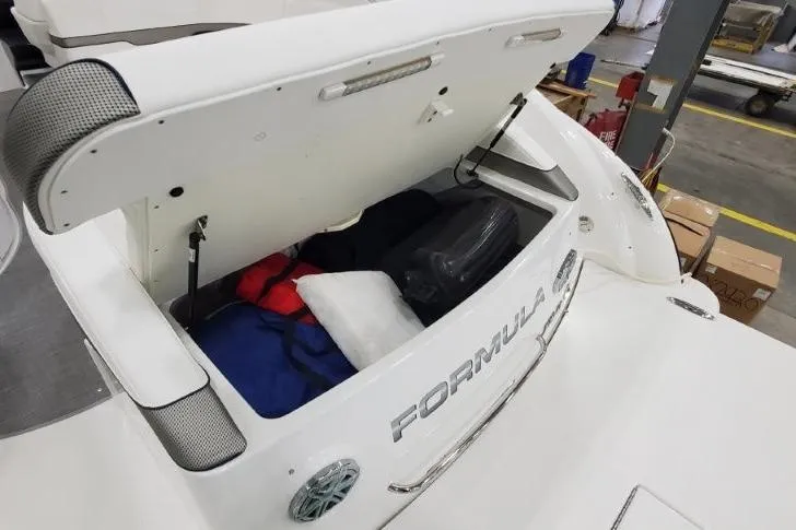 Slide: The Image of 2016 Formula 370 Super Sport boat with open storage compartment, revealing life jackets and gear. - 19