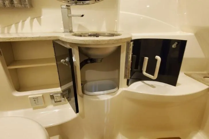 Slide: The Image of 2016 Formula 370 Super Sport bathroom with open cabinets and modern sink design. - 37