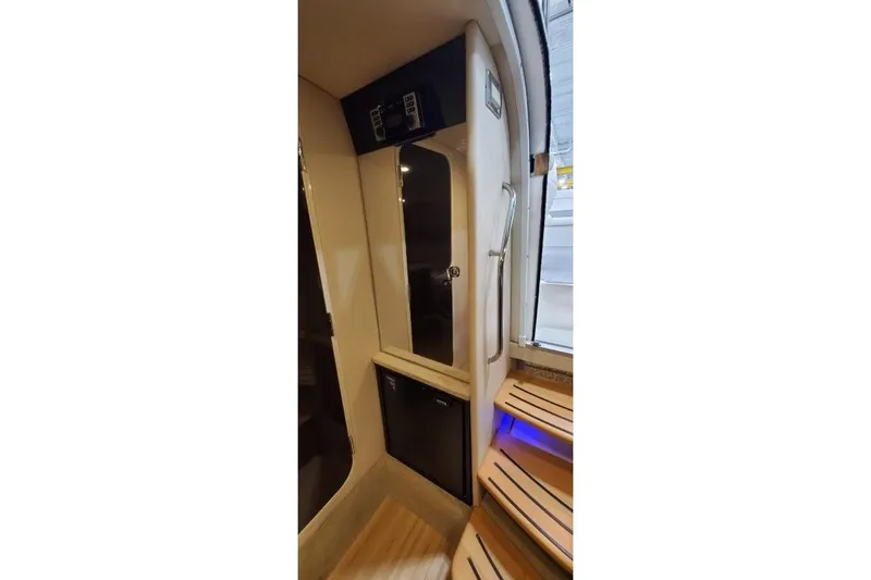 Slide: The Image of Interior of 2016 Formula 370 Super Sport boat with sleek design and wooden steps. - 39