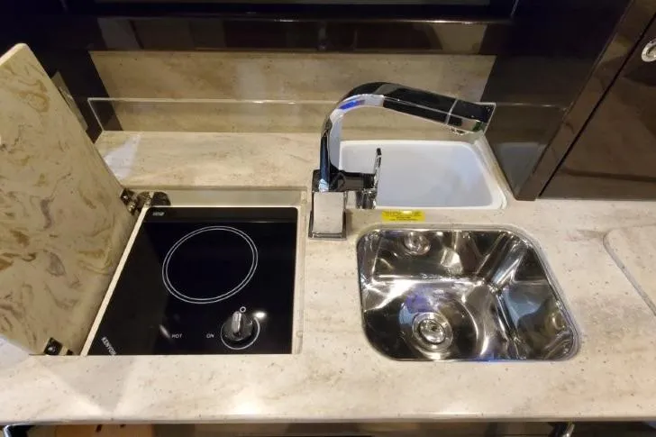 Slide: The Image of 2016 Formula 370 Super Sport yacht kitchen with sink and stovetop. - 42