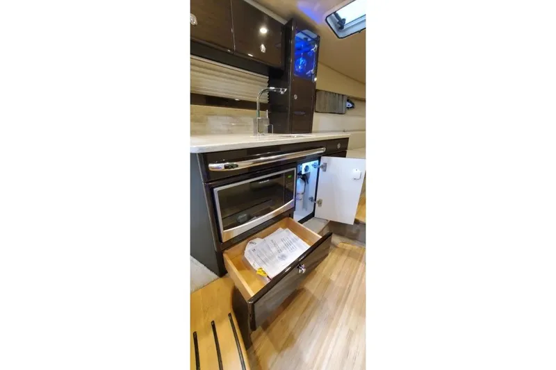 Slide: The Image of Interior of 2016 Formula 370 Super Sport yacht kitchen with microwave and storage. - 45