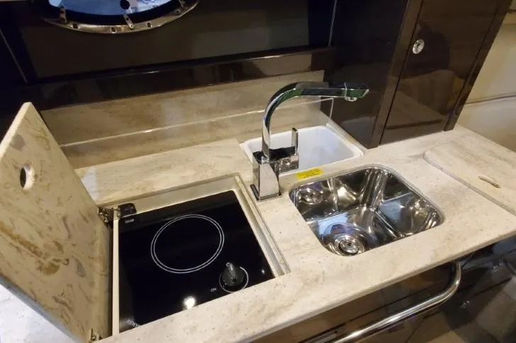 Slide: The Image of 2016 Formula 370 Super Sport yacht kitchen with sink, stove, and modern faucet. - 54