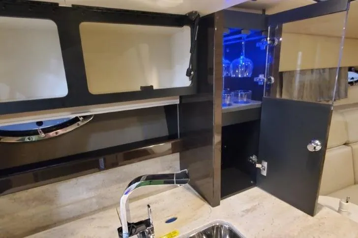 Slide: The Image of 2016 Formula 370 Super Sport yacht interior with modern kitchen and glass storage. - 55