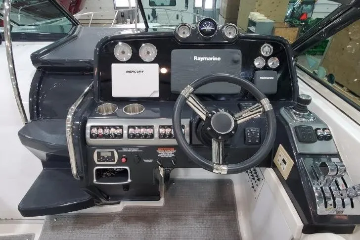 Slide: The Image of 2016 Formula 370 Super Sport boat dashboard with steering wheel and navigation controls. - 63