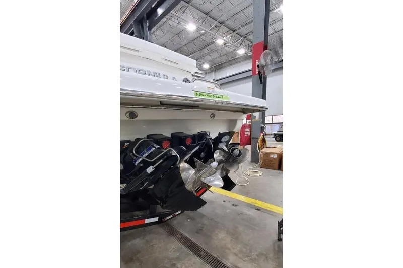 Slide: The Image of 2016 Formula 370 Super Sport boat in a warehouse, showcasing powerful engines and propellers. - 67