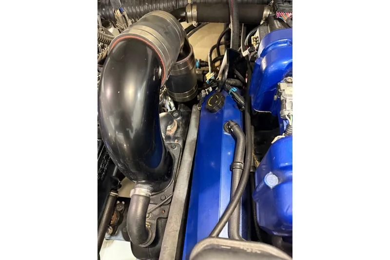 Slide: The Image of Engine compartment of a 2016 Formula 370 Super Sport with blue components and black tubing. - 73