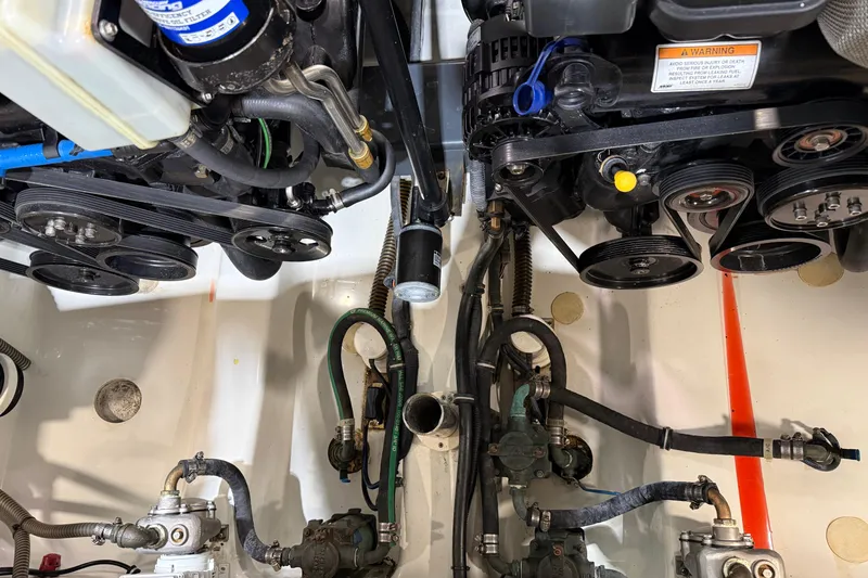Slide: The Image of Engine compartment of a 2016 Formula 370 Super Sport boat, showcasing belts and hoses. - 80
