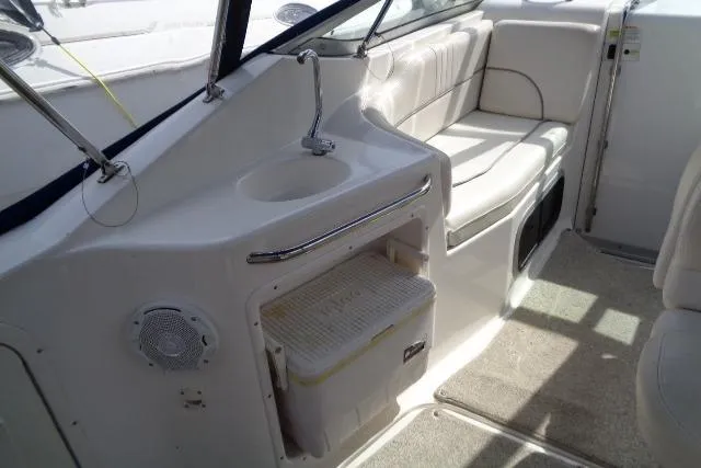 Slide: The Image of 2006 Chaparral Signature 240 boat interior with seating, sink, and storage area. - 12