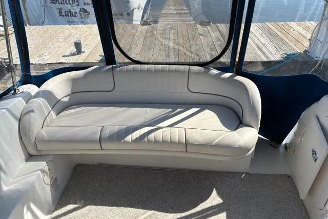 Slide: The Image of 2006 Chaparral Signature 240 boat interior with cushioned seating and dock view. - 14