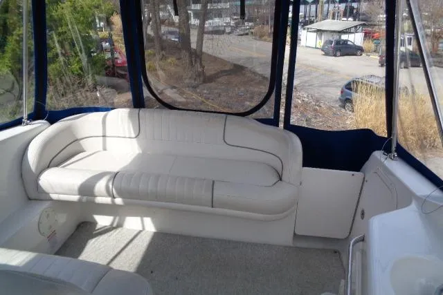 Slide: The Image of 2006 Chaparral Signature 240 boat interior with white seating and blue canopy. - 15