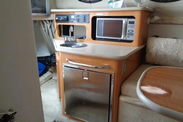 Slide: The Image of 2006 Chaparral Signature 240 boat interior with kitchenette, microwave, and seating area. - 17
