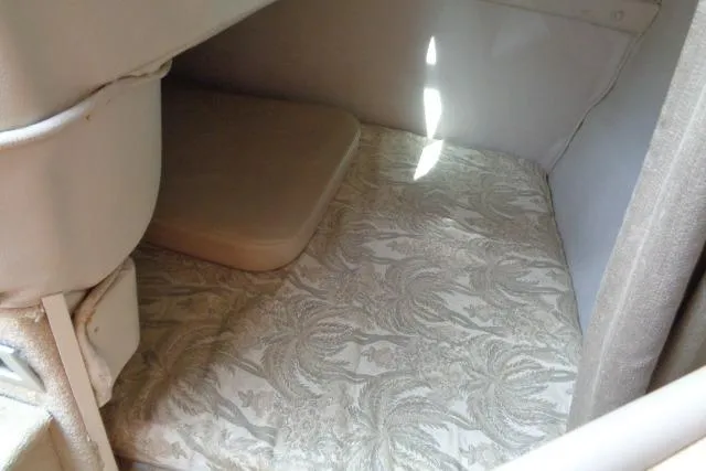 Slide: The Image of 2006 Chaparral Signature 240 cabin interior with patterned upholstery and compact seating area. - 19