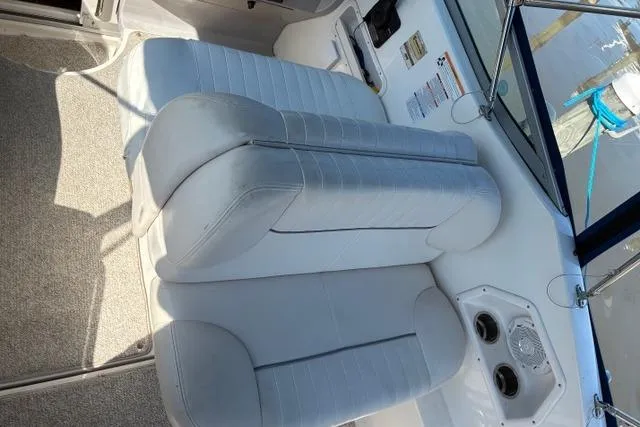Slide: The Image of 2006 Chaparral Signature 240 boat interior with white cushioned seating. - 2