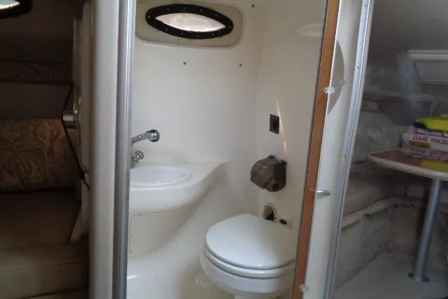 Slide: The Image of 2006 Chaparral Signature 240 boat interior with compact bathroom and seating area. - 20