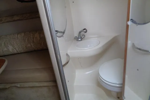 Slide: The Image of 2006 Chaparral Signature 240 boat interior with compact bathroom and seating area. - 21