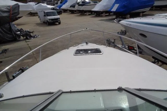 Slide: The Image of 2006 Chaparral Signature 240 boat in storage, surrounded by other covered boats. - 23