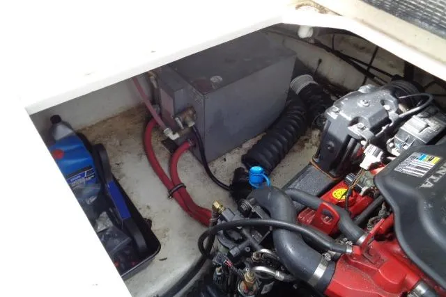 Slide: The Image of Engine compartment of a 2006 Chaparral Signature 240 boat, showing mechanical components and wiring. - 25