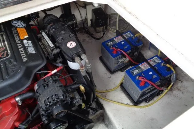 Slide: The Image of Engine compartment of 2006 Chaparral Signature 240 with batteries and Volvo Penta engine. - 26