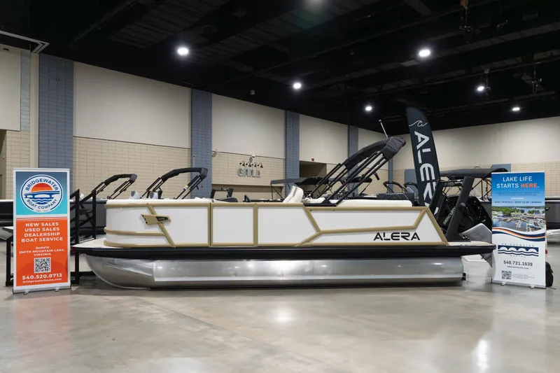 Slide: The Image of 2026 Alera M23Q boat displayed indoors with promotional banners. - 1