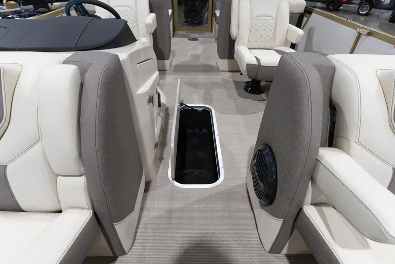 Slide: The Image of 2026 Alera M23Q boat interior with open storage compartment and luxurious seating. - 12