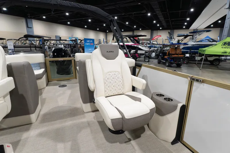Slide: The Image of 2026 Alera M23Q boat interior with luxurious seating at a boat show. - 7