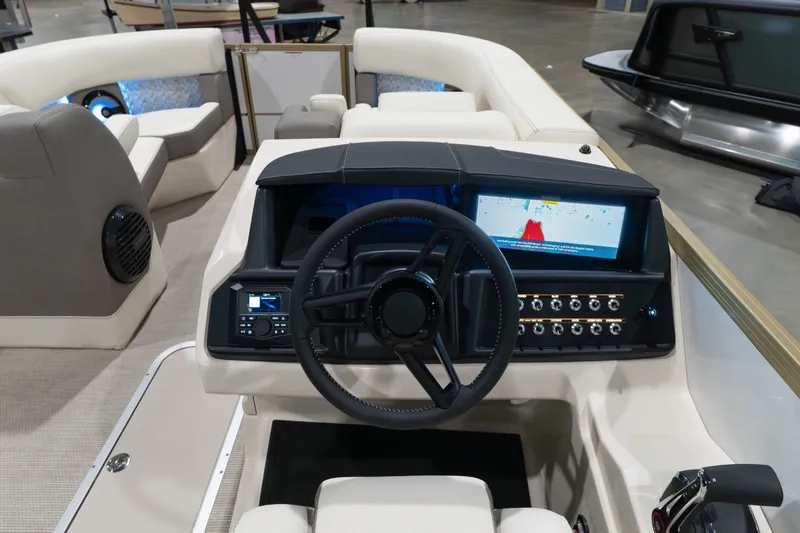Slide: The Image of Interior view of 2026 Alera M23Q boat dashboard with steering wheel and digital display. - 8