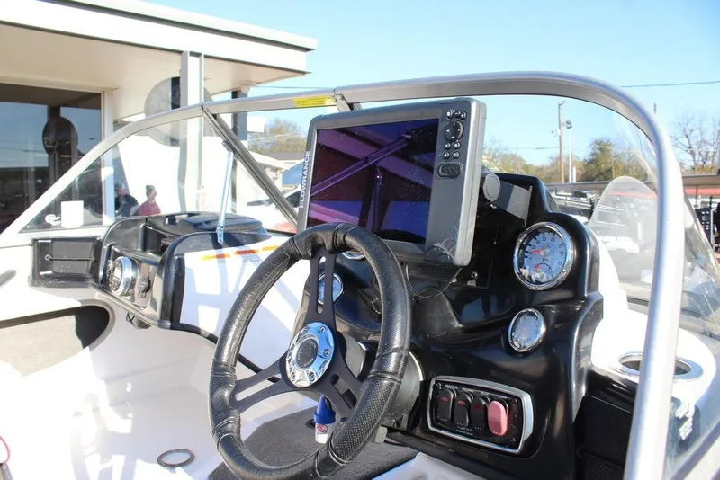 Slide: The Image of 2018 Nitro Z19 Sport boat dashboard with steering wheel and navigation display. - 11