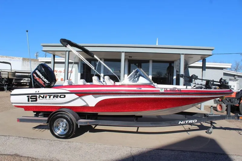 Slide: The Image of 2018 Nitro Z19 Sport boat with Mercury engine on trailer, parked outdoors. - 3