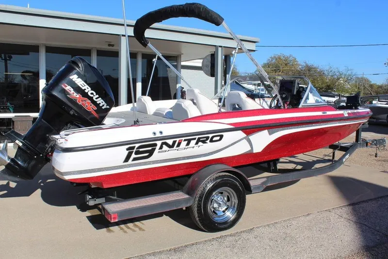 Slide: The Image of 2018 Nitro Z19 Sport boat with Mercury engine on trailer, parked outdoors. - 6