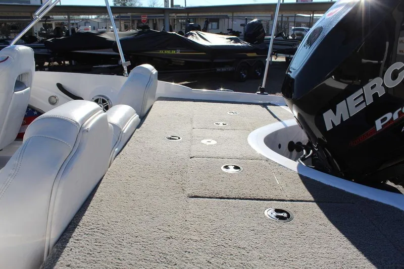 Slide: The Image of 2018 Nitro Z19 Sport boat interior with Mercury engine, featuring white seating and carpeted deck. - 7