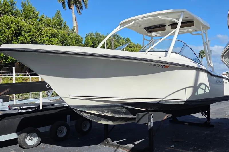 The Image of 2020 Key West 239 DFS boat on trailer, surrounded by lush greenery and clear blue sky. - 1