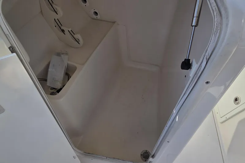 Slide: The Image of 2020 Key West 239 DFS boat storage compartment interior with hydraulic support. - 10