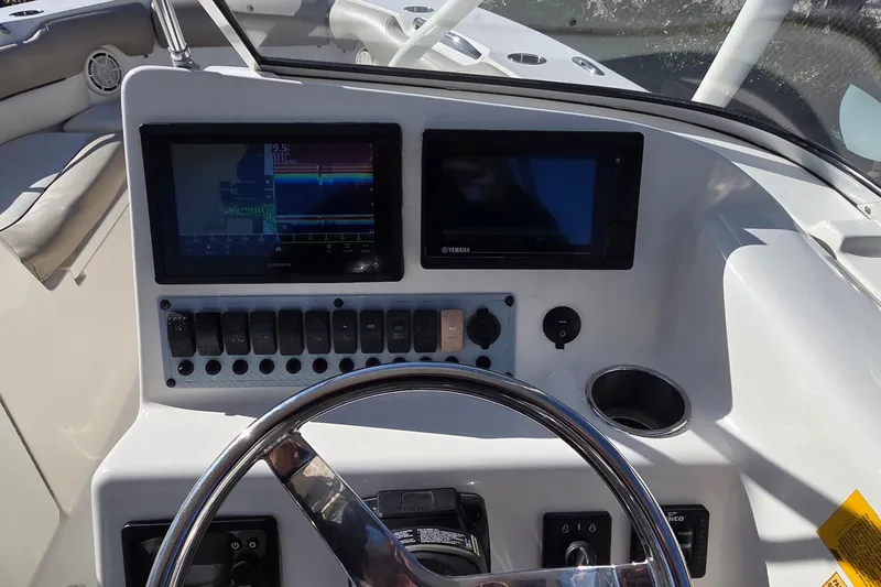 Slide: The Image of Dashboard of 2020 Key West 239 DFS boat with dual screens and controls. - 14