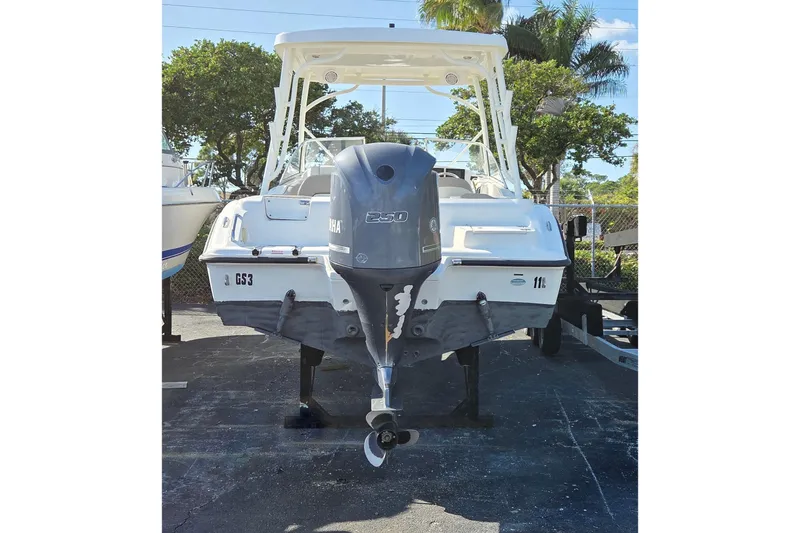 Slide: The Image of 2020 Key West 239 DFS boat with Yamaha outboard motor, parked outdoors. - 4