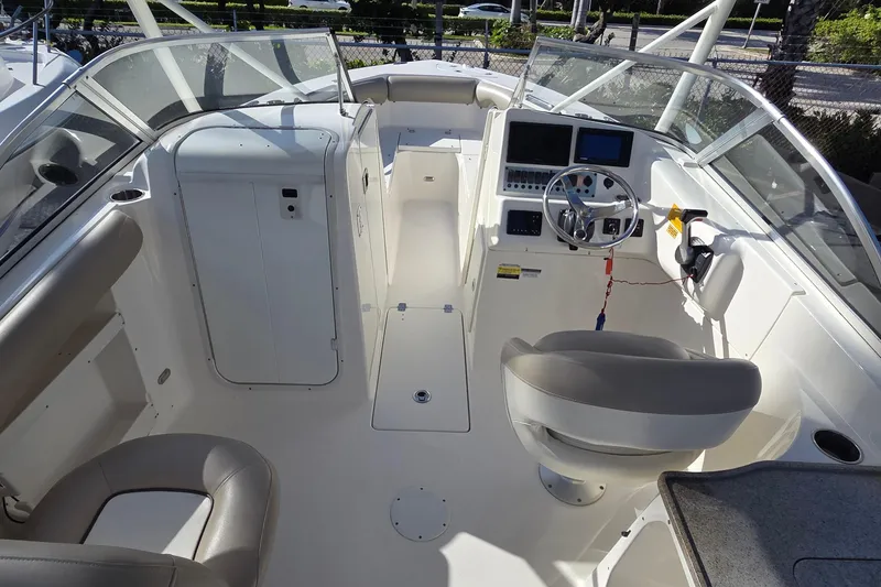 Slide: The Image of 2020 Key West 239 DFS boat interior with steering wheel and seating area. - 7