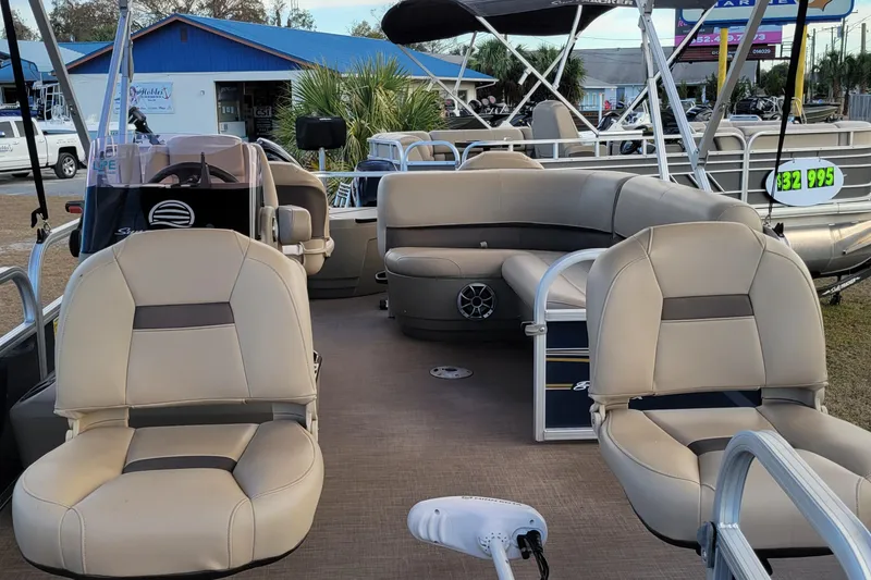 Slide: The Image of 2024 Sun Tracker Bass Buggy 18 DLX pontoon boat interior with seating and steering console. - 6