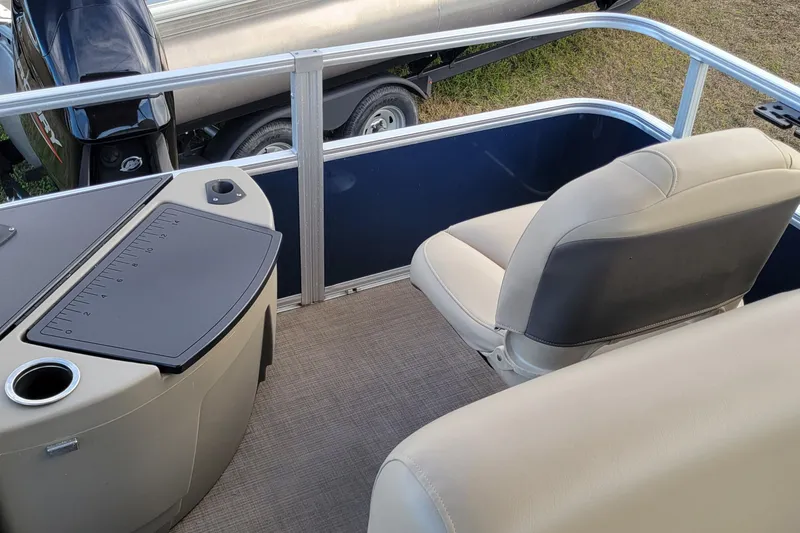 Slide: The Image of 2024 Sun Tracker Bass Buggy 18 DLX interior with seating and console details. - 7