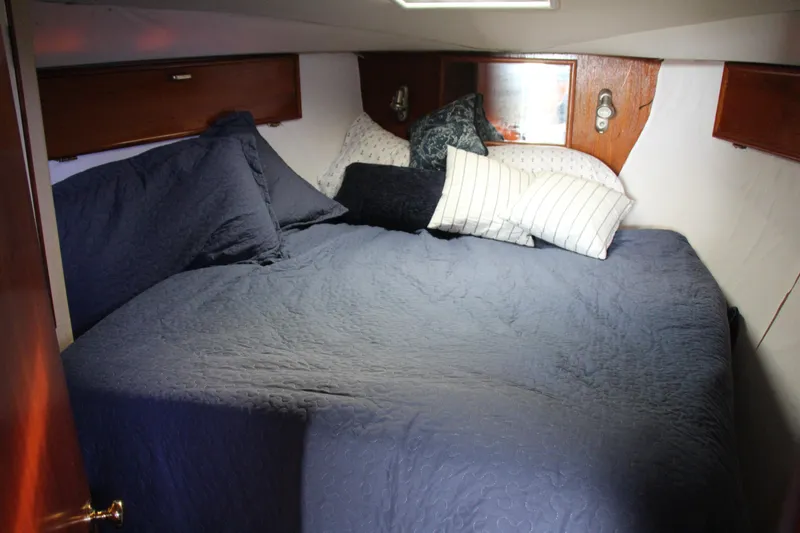 Slide: The Image of Cozy cabin interior of 1989 Ocean Yachts 35 Super Sport with blue bedding and pillows. - 20