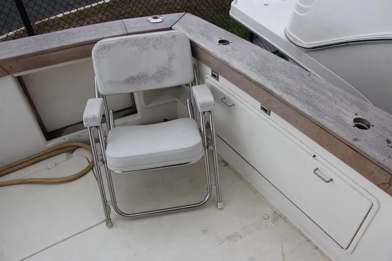 Slide: The Image of 1989 Ocean Yachts 35 Super Sport boat deck with a weathered white chair. - 8