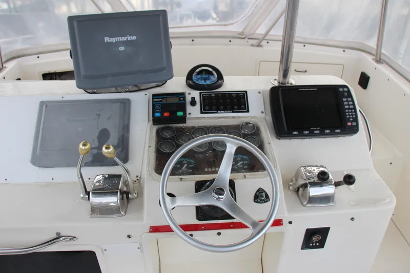 Slide: The Image of 1989 Ocean Yachts 35 Super Sport helm with navigation equipment and steering wheel. - 9