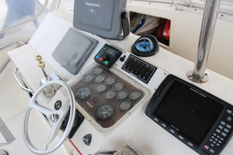 Slide: The Image of Control panel of 1989 Ocean Yachts 35 Super Sport with steering wheel and navigation instruments. - 11